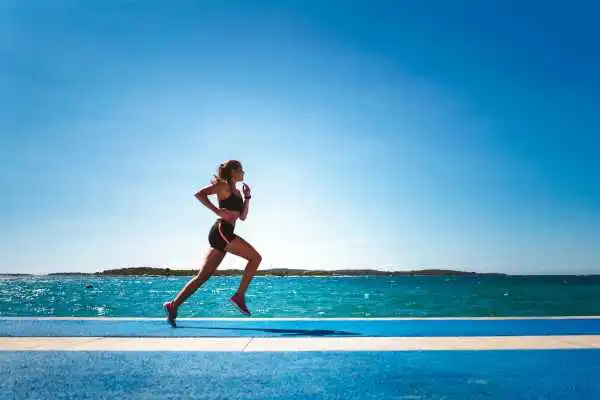 Woman running showing strong leg muscle Kingswinford